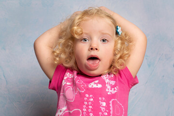 Naklejka premium Portrait of a cute little curly blonde 2 year old girl