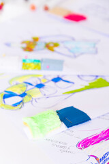 clothes, designer, indoor, drawing, female, happy, studio, white, woman, young, design, dressmaker, dress, fashion, colours, job, workplace, creating, brunette, lifestyle, creativity, colors, successf