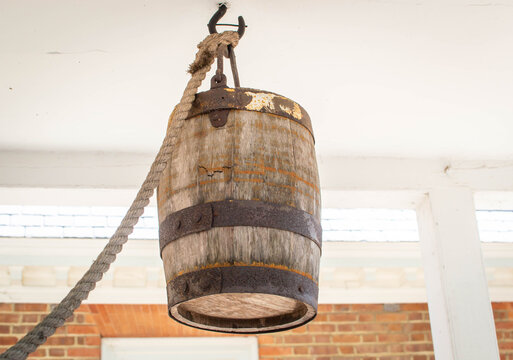 A wooden bucket above a well