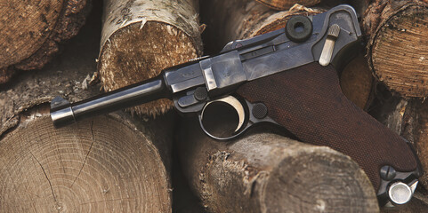 Old German pistol P08 on a wooden background.