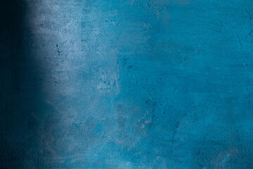Painted different shades of blue on the wall. Abstract blue background