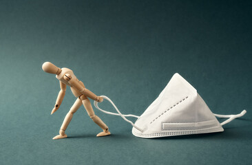 Tired figure dragging a white FFP2 or KN95 respirator, destined to prevent the coronavirus or...