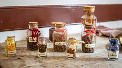 Corked assorted bottles of spices and wood
