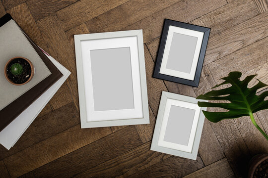 Set of portrait picture frame mockups. Wall art gallery. On old wooden bench, table. White wall background.  Scandinavian interior, neutral dark color palette.