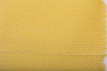 Yellow empty bees wax background with cells in close up