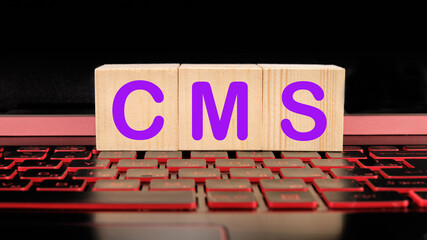 cubes on a laptop keyboard with a content management system CMS