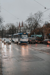Fototapeta na wymiar Rainy street of Riga with a Soviet tram and cars.