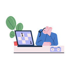 Young pensive man sitting and playing chess online on laptop