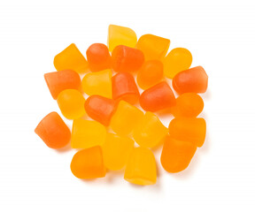 Close-up texture of orange and yellow multivitamin gummies on white background.  Healthy lifestyle concept.