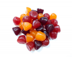 Close-up texture of red, orange and purple multivitamin gummies on white background. Healthy lifestyle concept.