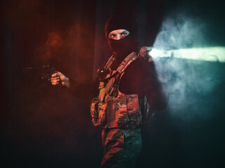 Special forces soldier with a pistol and a flashlight