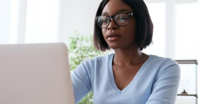 African american woman working on laptop at office