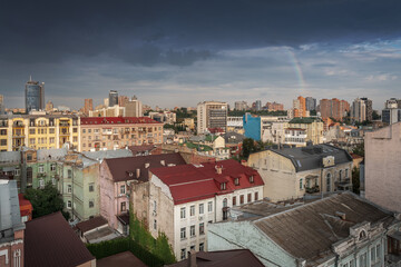 Fototapeta na wymiar Aerial view of Kyiv buildings with a rainbow on background - Kiev, Ukraine