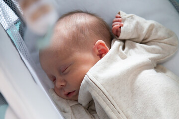 Adorable new born baby girl with bright blue eyes and uniform contemporary background