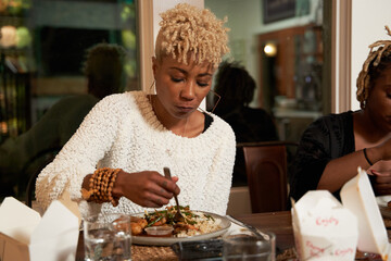 Friends eating dinner together at home