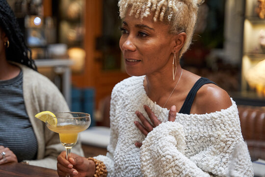 Black girlfriends talking at home during cozy self care retreat