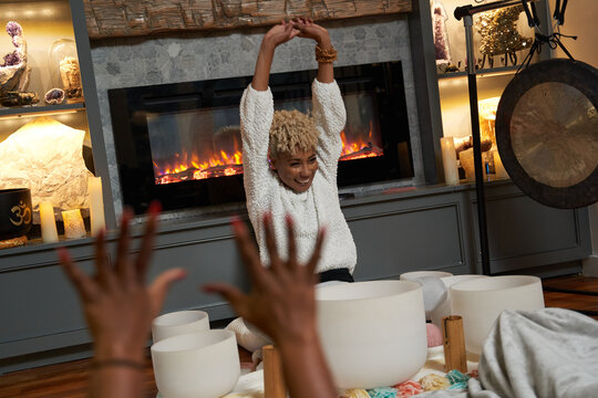 Women Stretching At Home In Front Of Fireplace