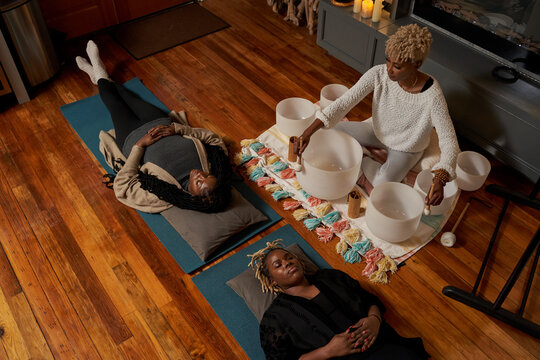 Black Women Having Peaceful Mediation Laying Down, Self Care Retreat