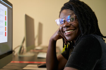 Black woman college student studying in computer lab