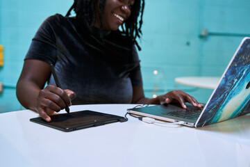 Black graphic design artist creative working on school project, on laptop