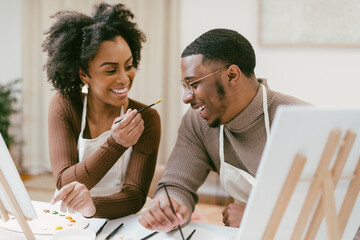 Black couple has fun painting and laughing during date night, paint and craft DIY