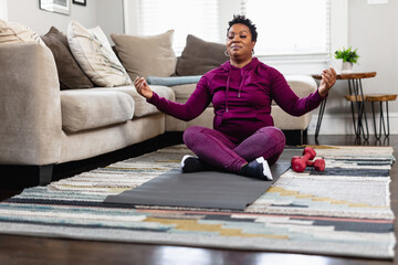 Black woman does peaceful meditation at home on floor