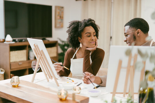 Black couple has fun painting and laughing during date night, paint and craft DIY