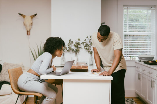 Cozy and comfy Black couple having conversation in kitchen