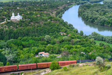 Freight train travels by rail near the Naslavcha village, Moldova