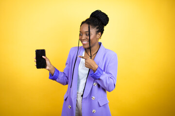 Young african american business woman showing screen smiling happy pointing with hand and finger