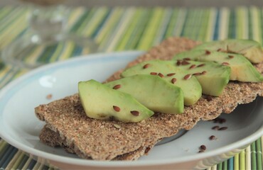 green healthy avocado and brown bread on a plate