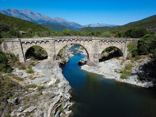Fototapeta na wymiar Old bridge with path in the mountains of Corsica France