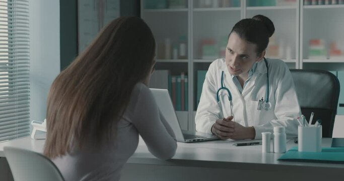 Doctor comforting a woman crying during a visit