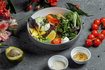 fresh healthy light breakfast, business lunch. Breakfast with poached egg, buckwheat, red fish, fresh salad, cucumbers, business lunch concept