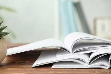 Open blank magazines on wooden table