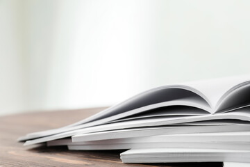 Open blank magazines on wooden table