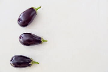 Fresh eggplants on light background