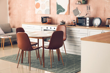 Stylish interior of modern kitchen with dining table