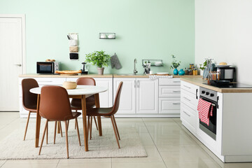 Stylish interior of modern kitchen with dining table
