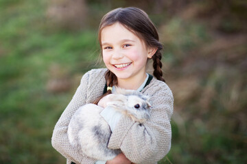 Pretty girl holding a rabbit
