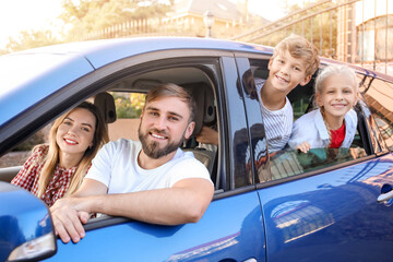 Happy family sitting in car