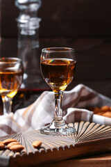 Composition with glasses of almond liquor and nuts on dark background