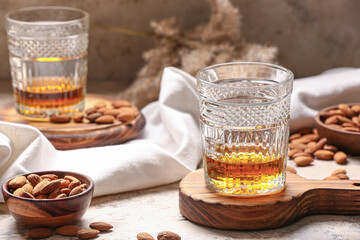 Glasses of almond liquor and nuts on table