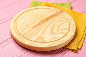 Cutting board on color wooden background