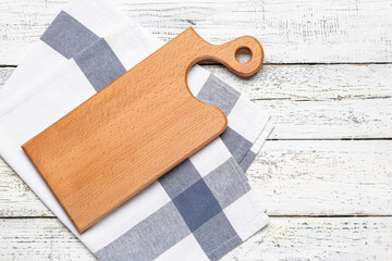 Cutting board on light wooden background
