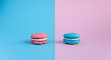 muted pink cookies with white cream on a blue background muted blue macaroon cookies with white cream on a pink background gender party decoration