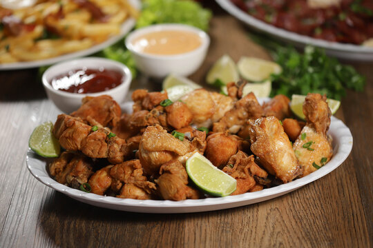 Portion Of Fried Chicken With Lemon. Lettuce, Green Onion, Ketchup And Mayonnaise