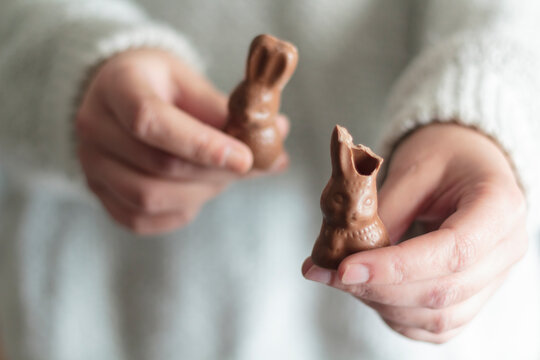 Woman hands holding bitten chocolate Easter bunny