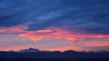 Fototapeta premium dramatic sunset over long's peak and the front range of the colorado rocky mountains as seen from broomfield, colorado