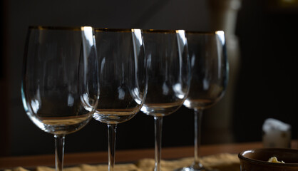 four glass goblets arranged in a row